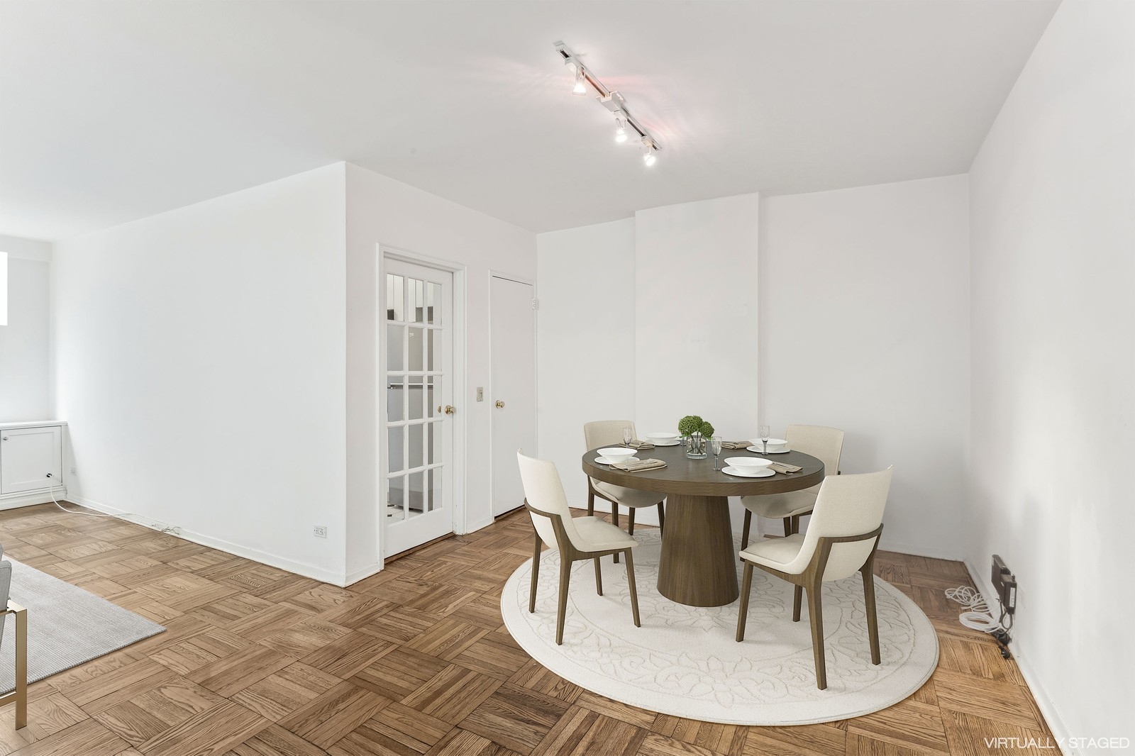 116 Central Park South, Unit 7C Manhattan, NY 10019 - Photo 2 of 6 a view of a dining room with furniture and wooden floor