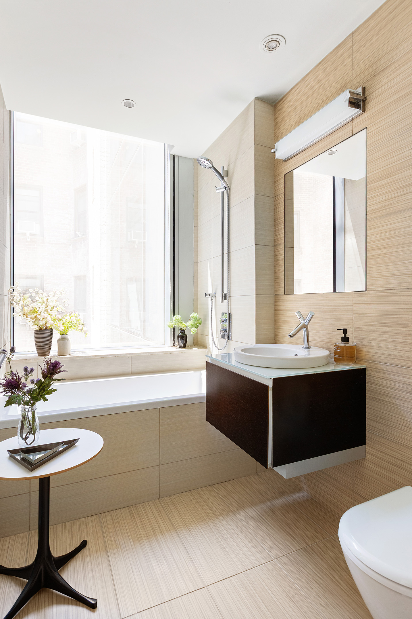 166 West 18th Street, Unit 4A Manhattan, NY 10011 - Photo 9 of 14 a spacious bathroom with a bathtub a sink and a window