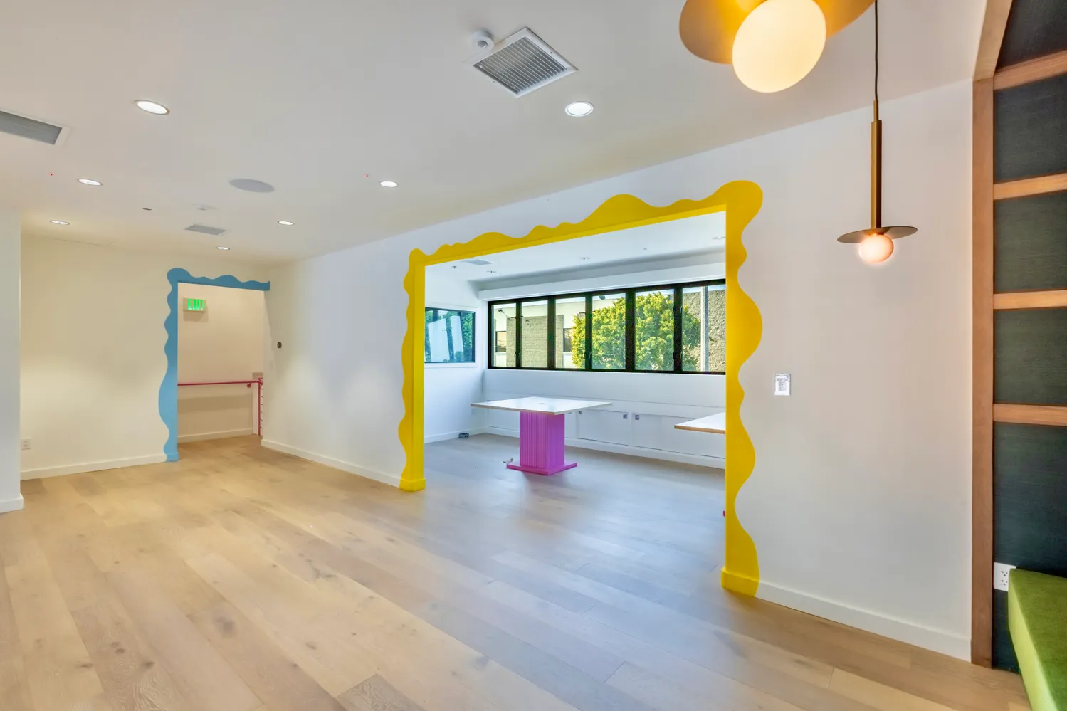 a living room with furniture and a floor to ceiling window