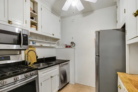 a kitchen with stainless steel appliances granite countertop a stove and a refrigerator