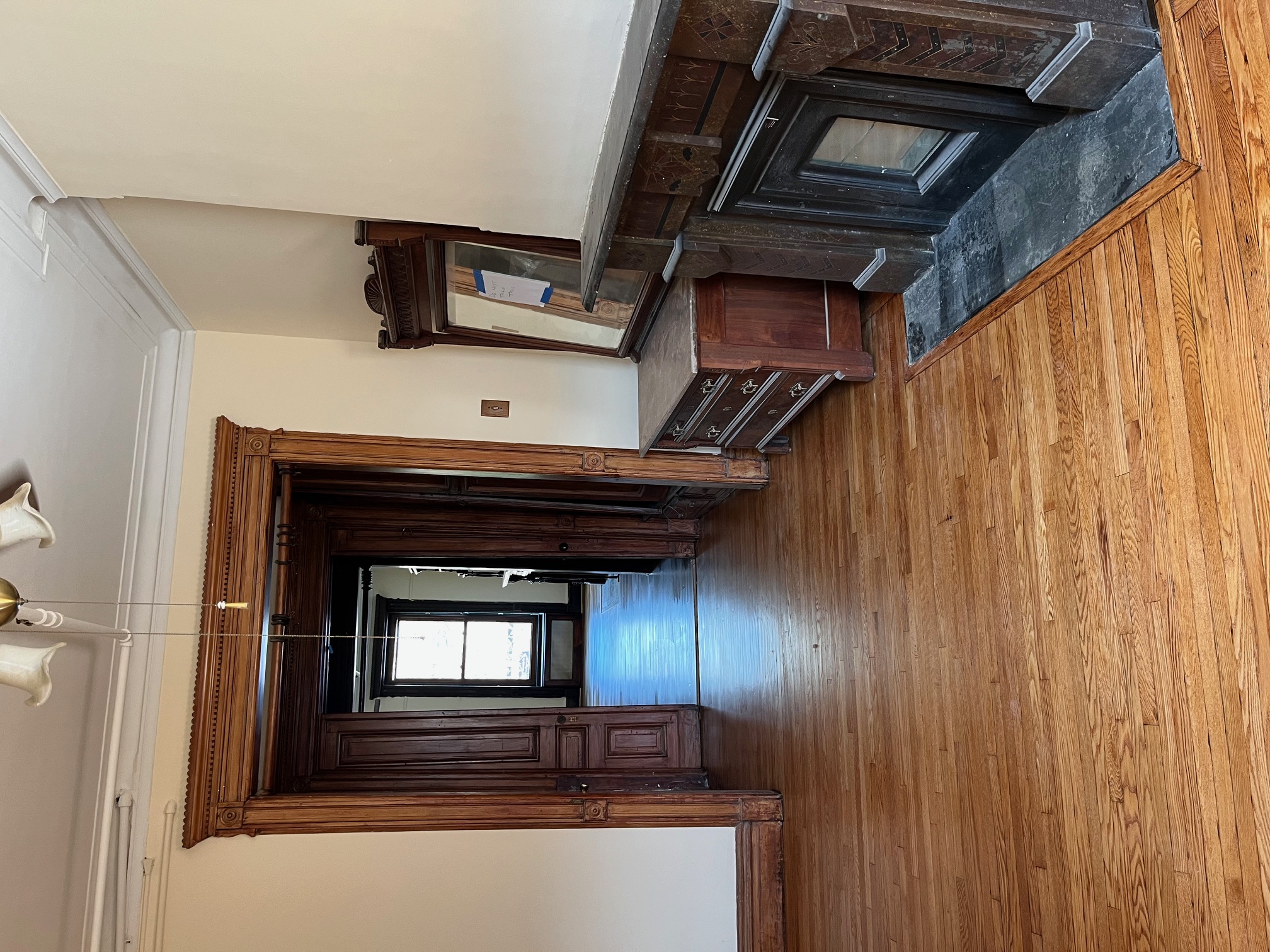 106 West 131st Street Manhattan, NY 10027 - Photo 12 of 16 a view of a livingroom with wooden floor and furniture