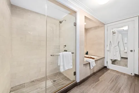 a bathroom with a double vanity sink toilet mirror and shower