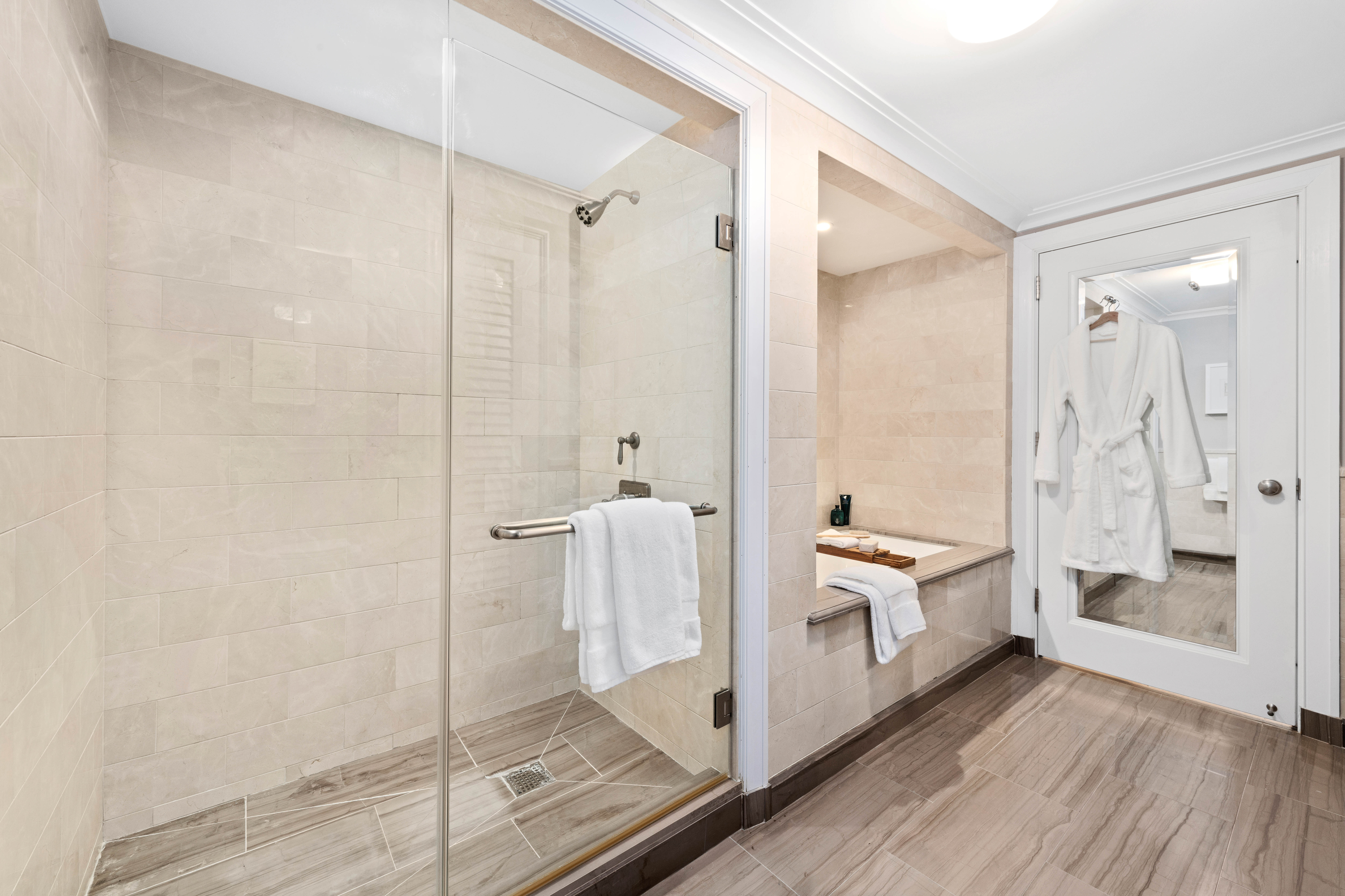 530 Park Avenue, Unit 12A Manhattan, NY 10065 - Photo 18 of 27 a bathroom with a double vanity sink toilet mirror and shower