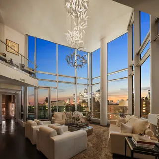 a living room with furniture city view and large windows