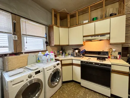a kitchen with a stove a sink and a microwave