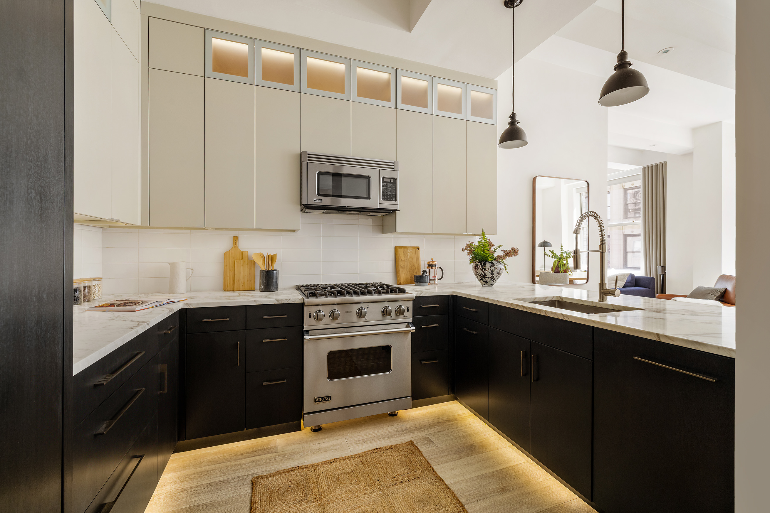 49 East 21st Street, Unit 9A Manhattan, NY 10010 - Photo 4 of 18 a kitchen with stainless steel appliances granite countertop a sink a stove top oven a counter space and cabinets