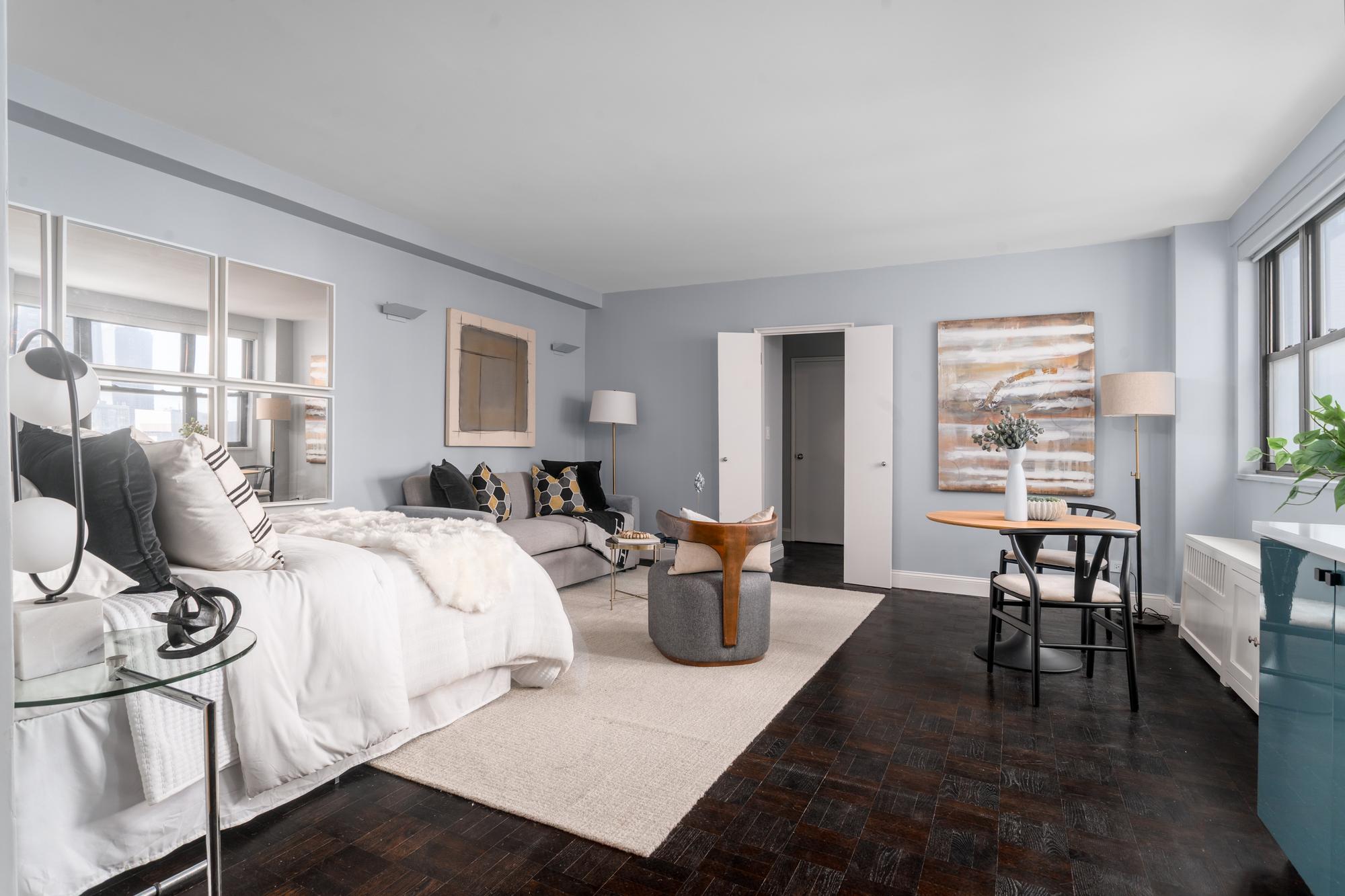 315 East 72nd Street, Unit 16A Manhattan, NY 10021 - Photo 5 of 12 a bed room with a bed and furniture