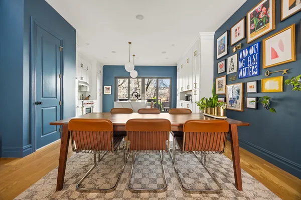 a dining room with chairs and a rug