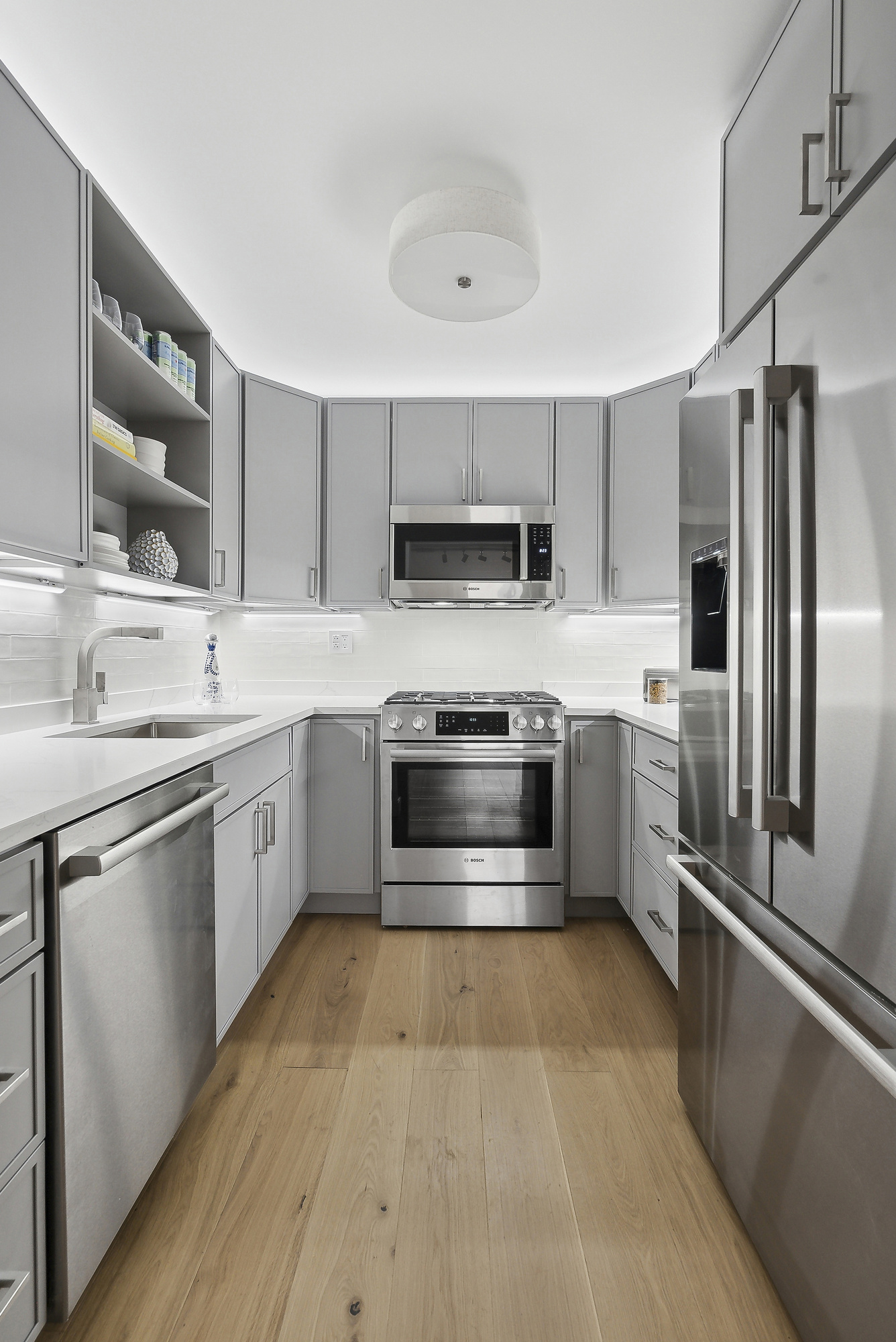 32 East 76th Street, Unit 805 Manhattan, NY 10021 - Photo 3 of 15 a kitchen with stainless steel appliances a stove a sink dishwasher a refrigerator and a oven