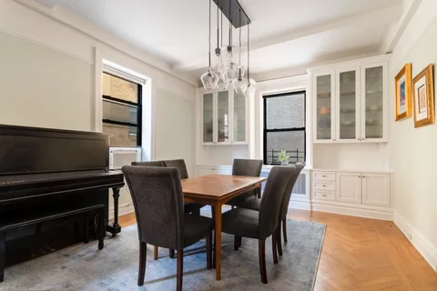 a dining room with furniture and window