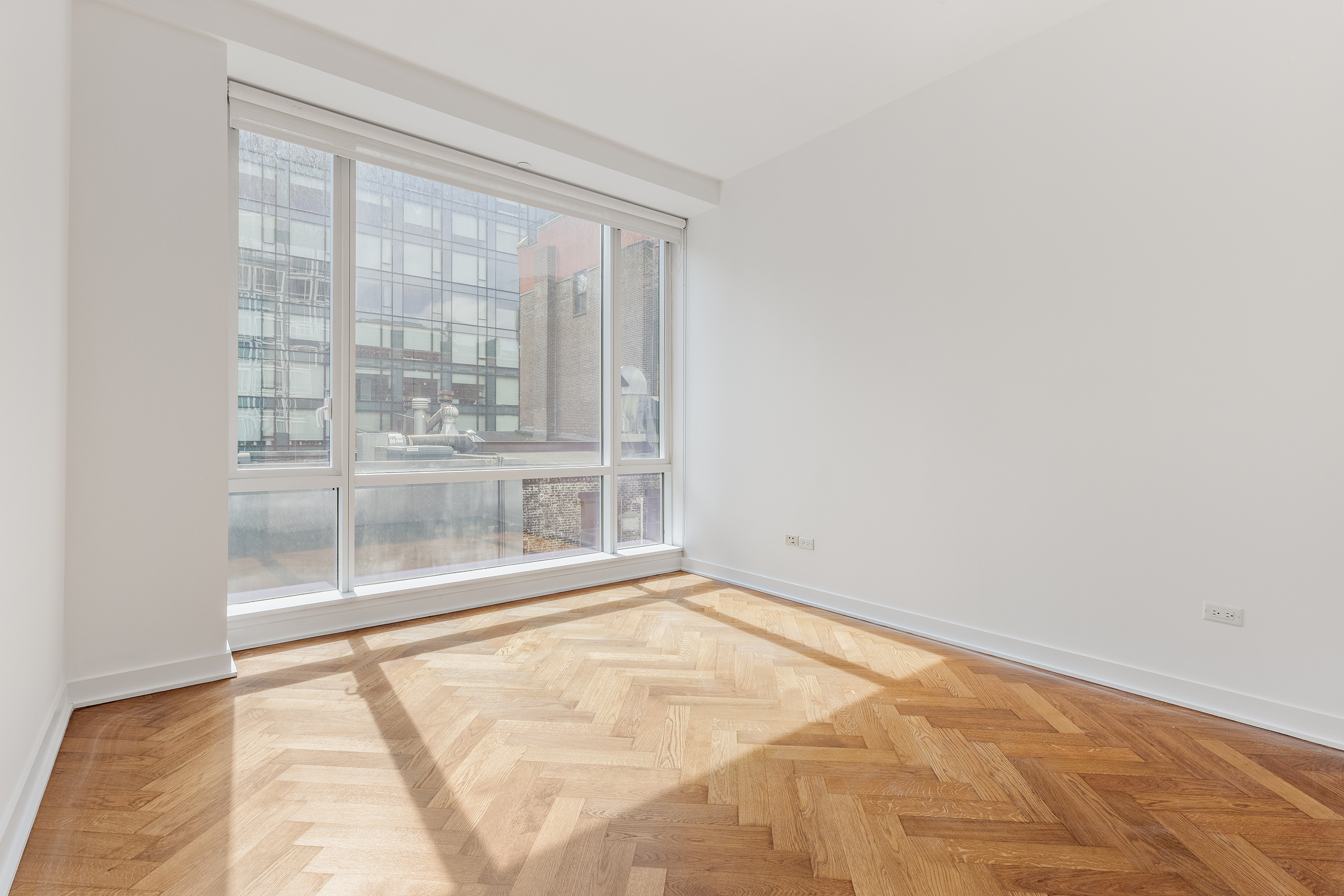 330 Spring Street, Unit 5A Manhattan, NY 10013 - Photo 10 of 13 a view of an empty room with a window