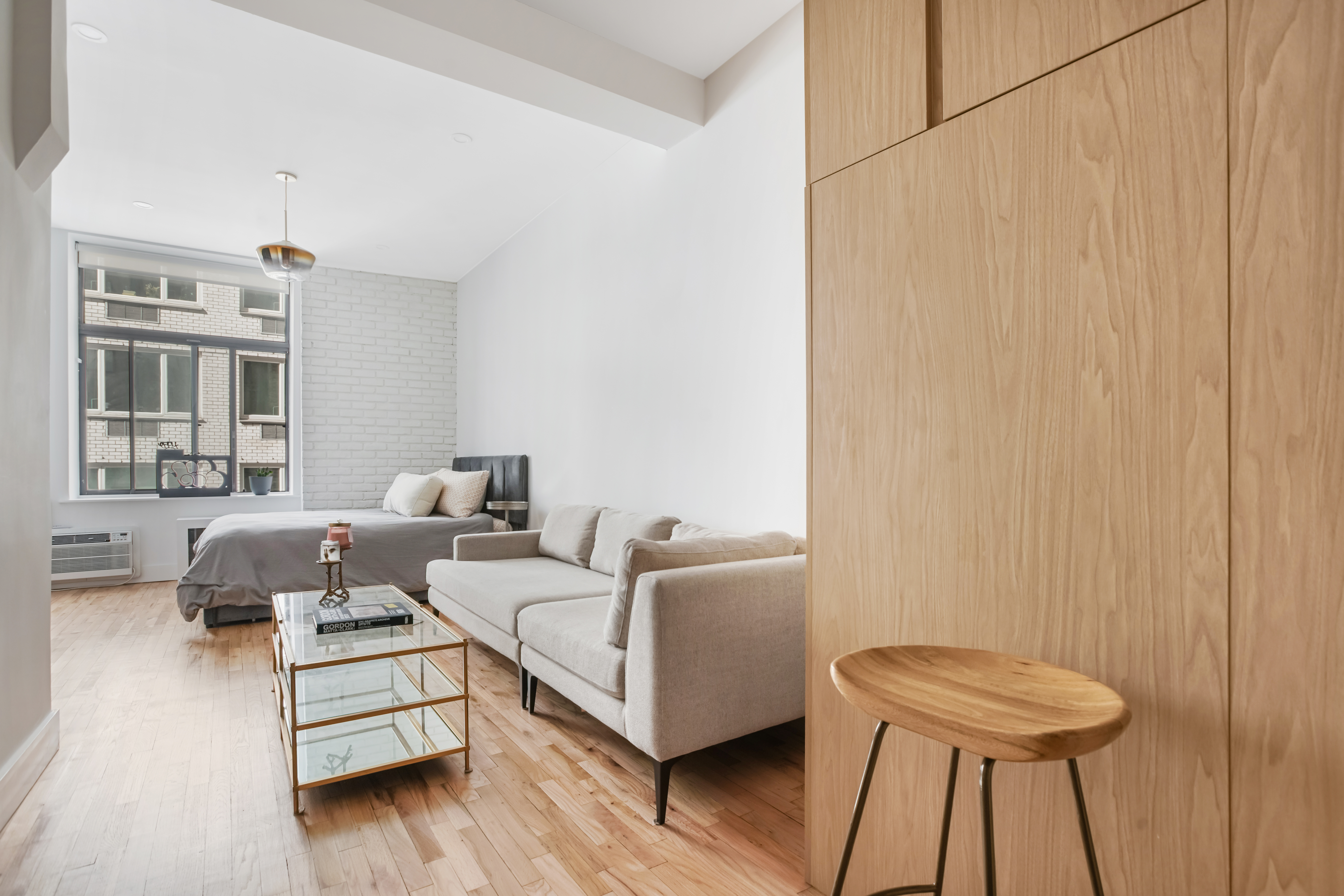 310 East 23rd Street, Unit 3B Manhattan, NY 10010 - Photo 2 of 11 a living room with furniture and a window