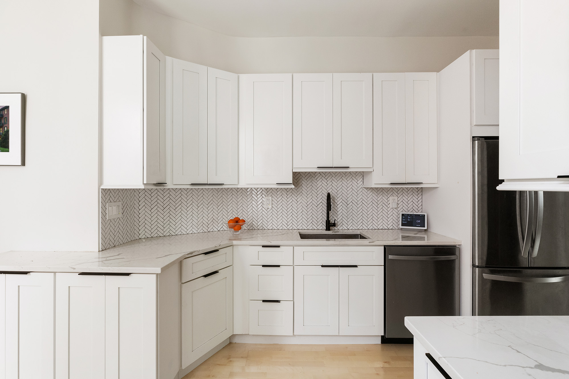330 East 94th Street, Unit 1AB Manhattan, NY 10128 - Photo 2 of 14 a kitchen with white cabinets and stainless steel appliances