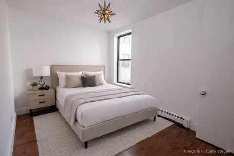 a bedroom with a bed and a window