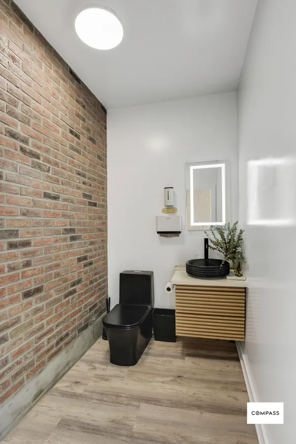 a bedroom with a bed and a desk with mirror