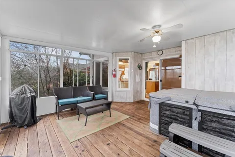 a living room with furniture and wooden floor