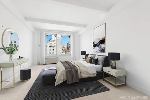 a bedroom with a bed wooden floor and window