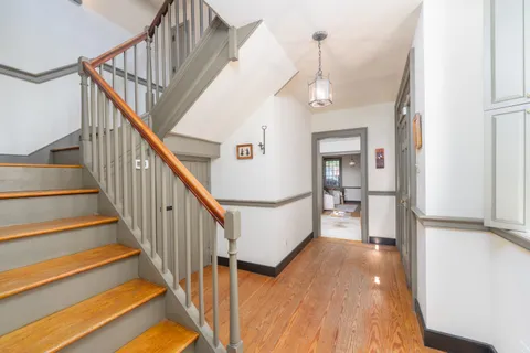 a view of entryway and hall with wooden floor