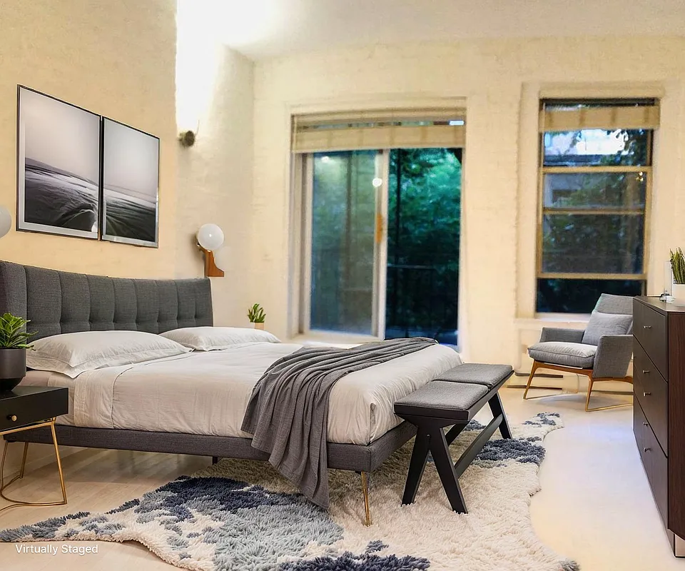 112 West 15th Street, Unit 2 Manhattan, NY 10011 - Photo 2 of 13 a bedroom with a bed and wooden floor