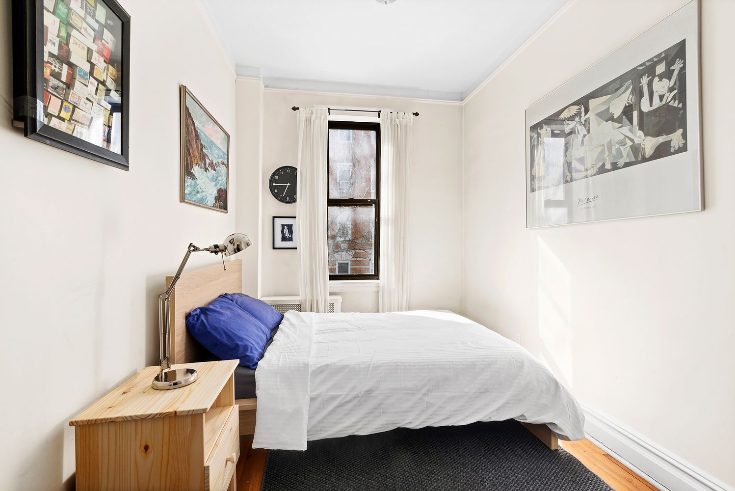 63 West 107th Street, Unit 33 Manhattan, NY 10025 - Photo 2 of 5 a bedroom with a bed and wooden floor