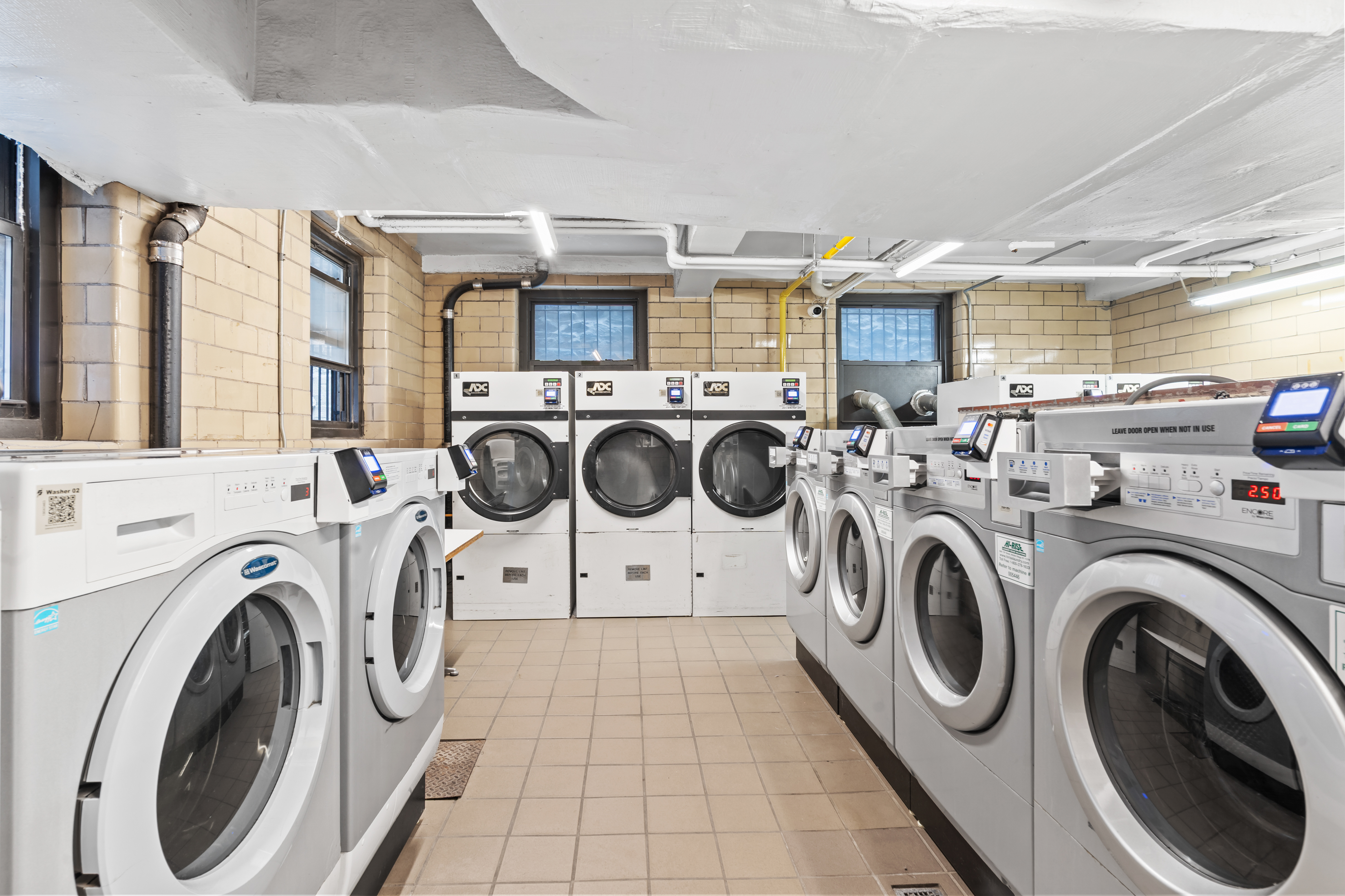 135 East 54th Street, Unit 3H Manhattan, NY 10022 - Photo 6 of 7 a utility room with dryer and washer