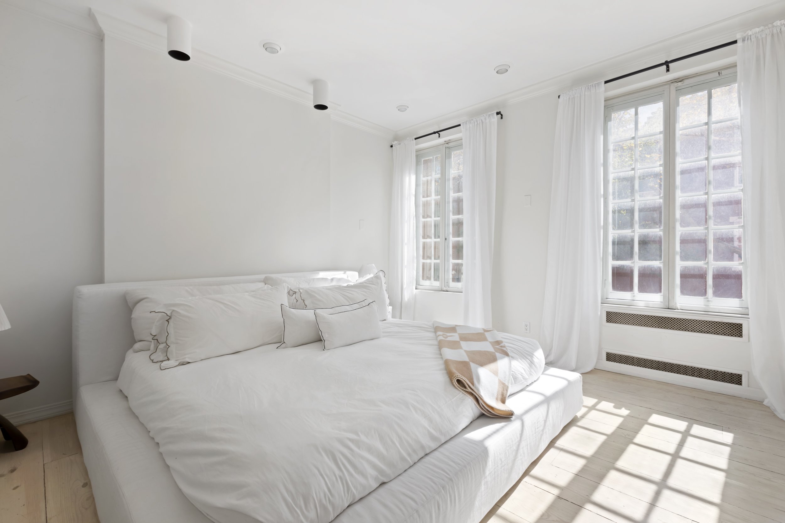 367 Bleecker Street Manhattan, NY 10014 - Photo 6 of 11 a bedroom with a bed and a window