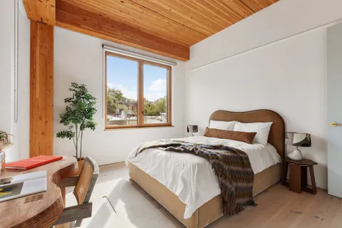 a bedroom with a bed and a chair