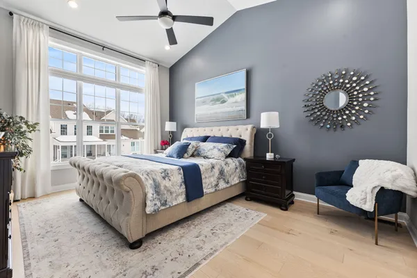 a bedroom with a bed dresser and a window