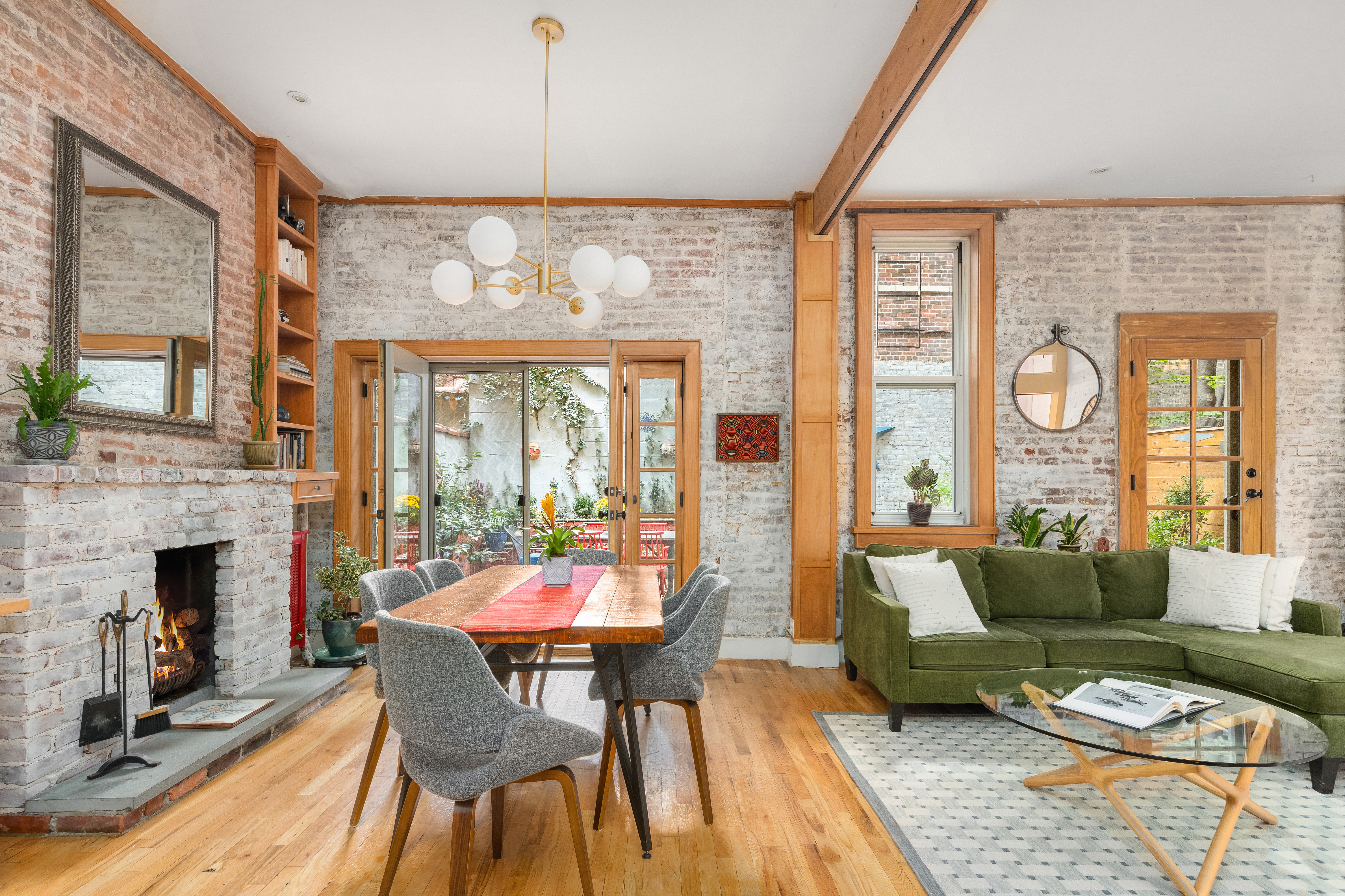92 Horatio Street, Unit 1J Manhattan, NY 10014 - Photo 3 of 16 a living room with furniture a fireplace and a floor to ceiling window