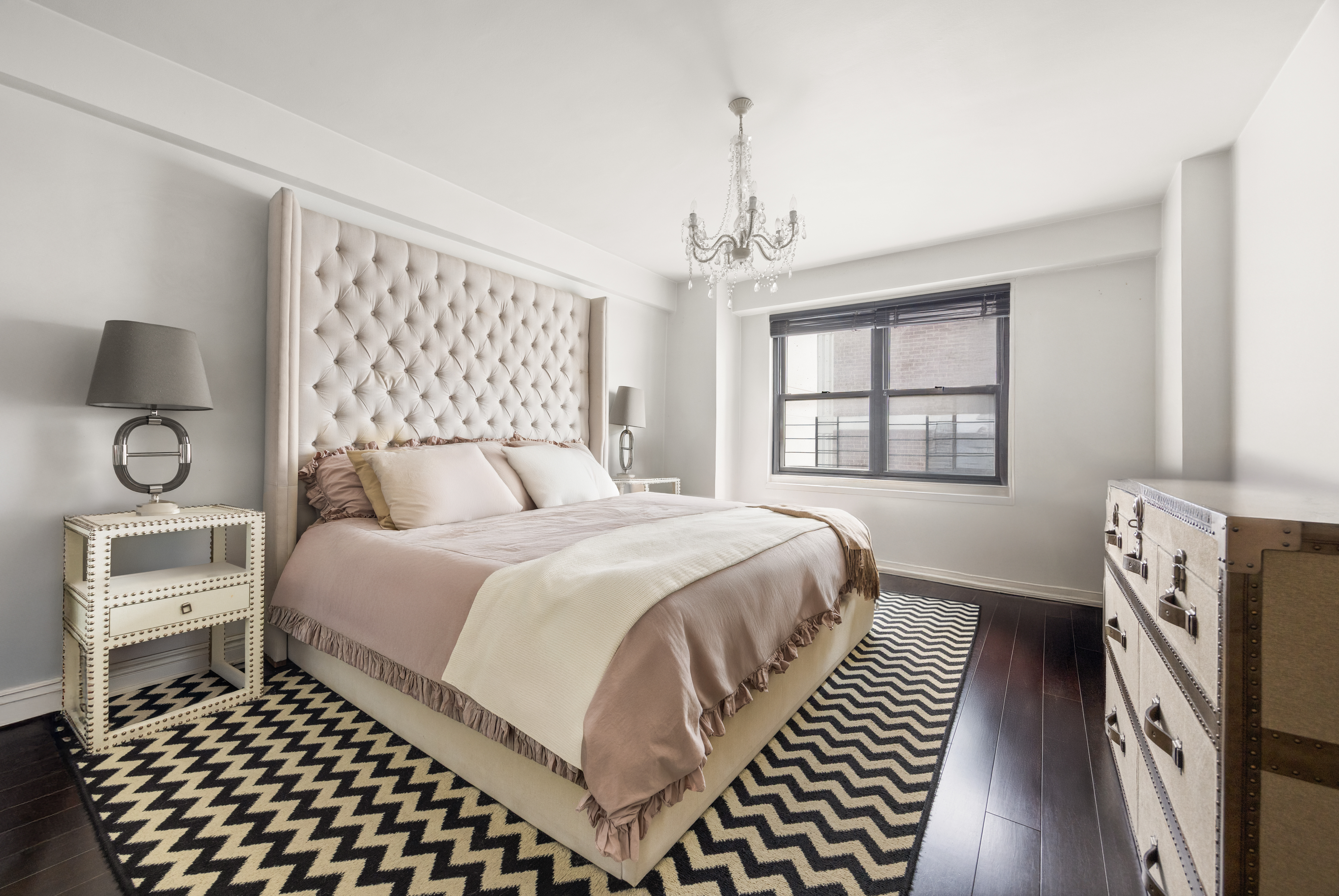 136 East 56th Street, Unit 10JK Manhattan, NY 10022 - Photo 4 of 12 a bedroom with a bed and a window