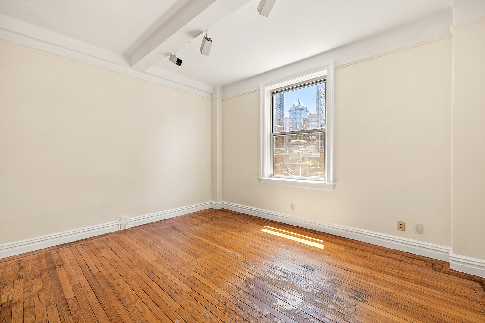 345 West 55th Street, Unit 8AB Manhattan, NY 10019 - Photo 11 of 14 an empty room with wooden floor and windows