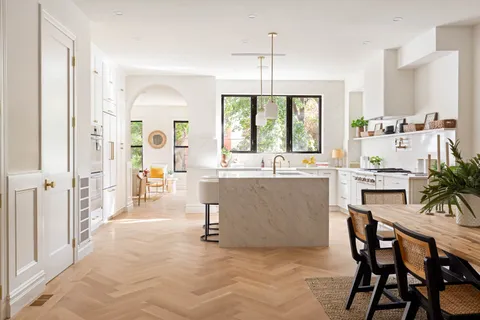 a large white kitchen with a large window