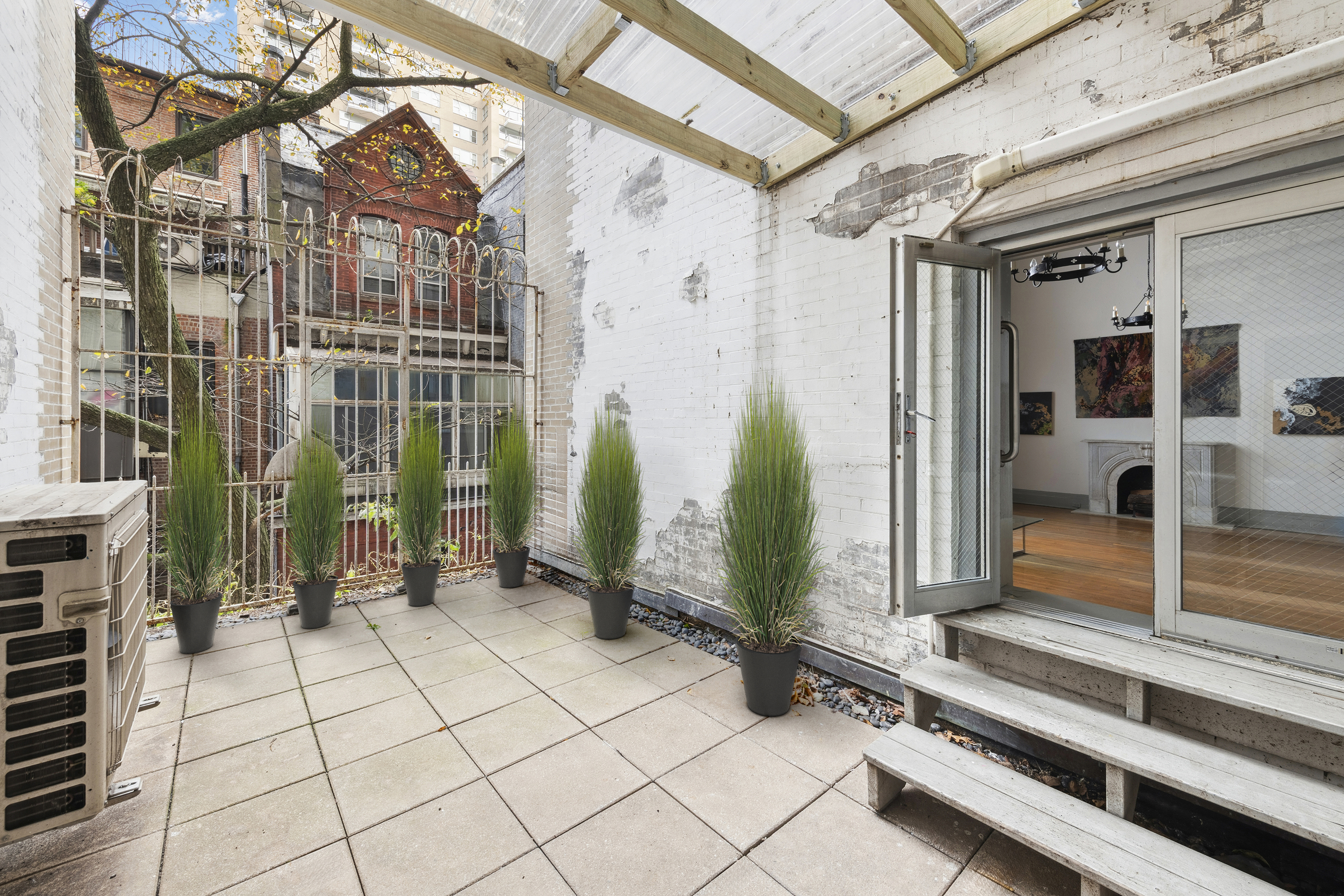 1 West 67th Street, Unit 303-304 Manhattan, NY 10023 - Photo 11 of 18 a view of a porch with a bench and potted plants