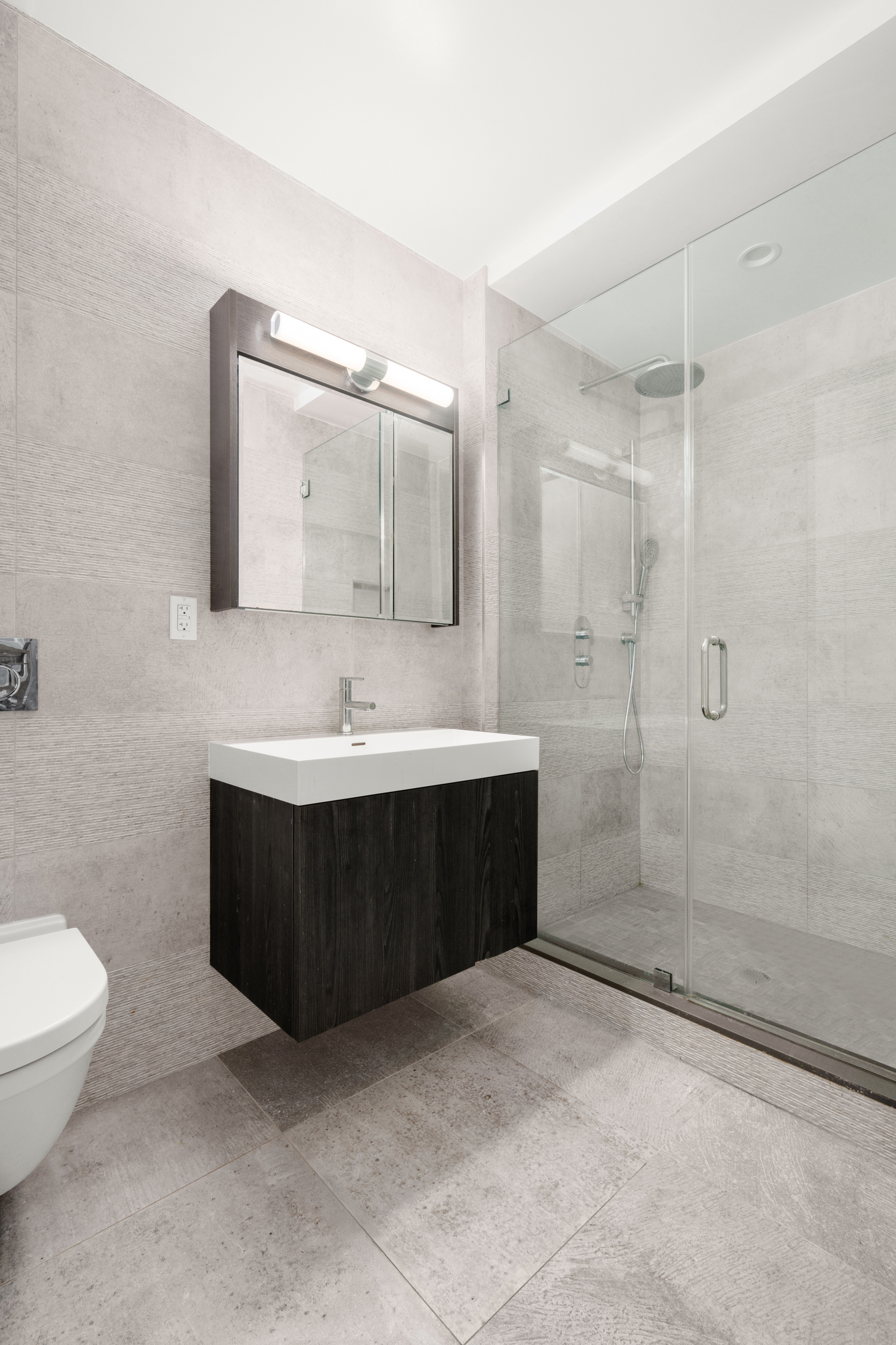 40 Huntington Street, Unit 2C Brooklyn, NY 11231 - Photo 6 of 9 a bathroom with a bathtub shower sink mirror and toilet