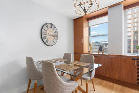 a dining room with furniture and window