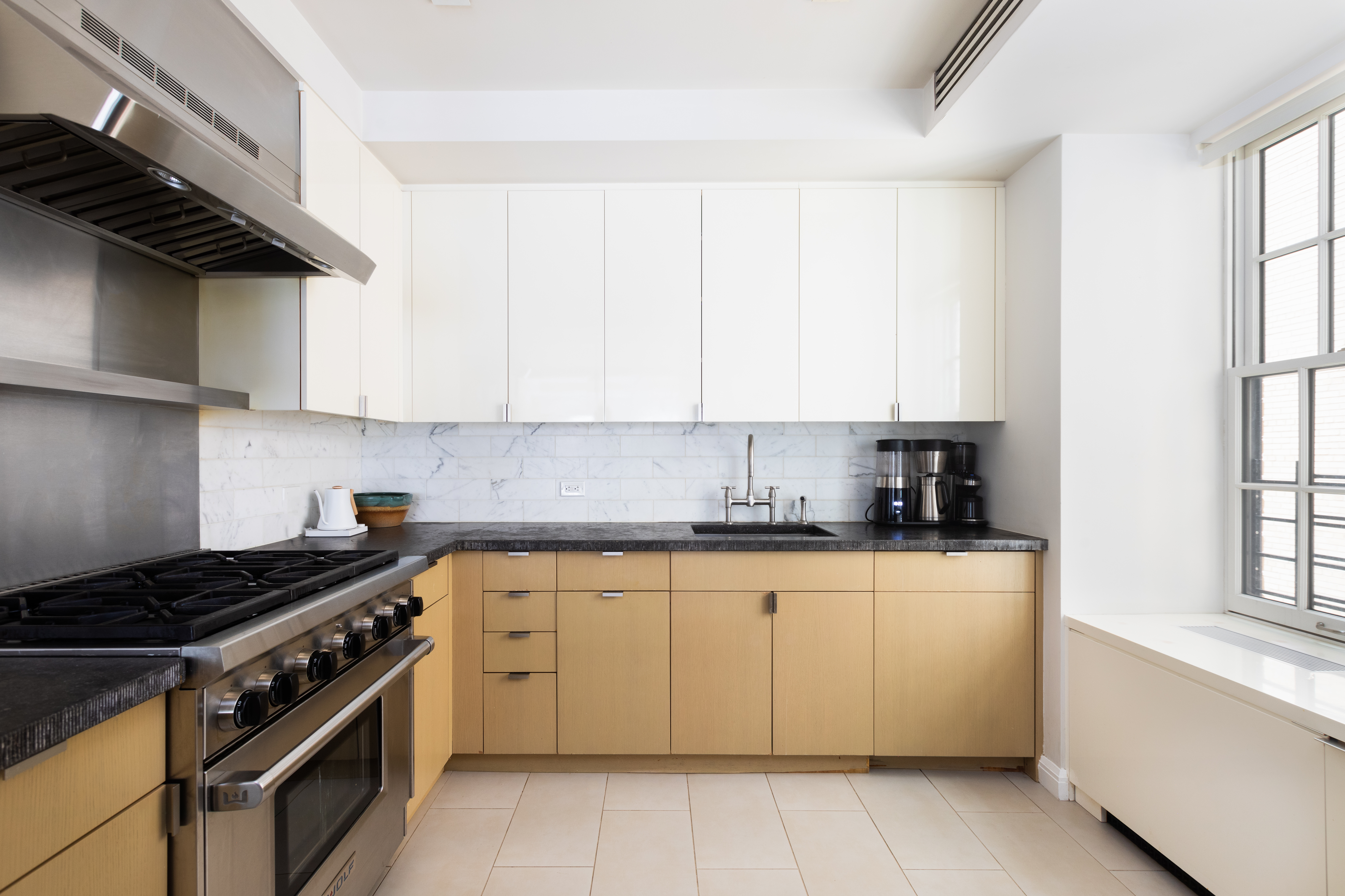 141 East 88th Street, Unit 5 Manhattan, NY 10128 - Photo 6 of 12 a kitchen with cabinets appliances a sink and a window