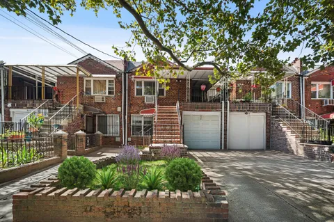 a front view of a house with a garden