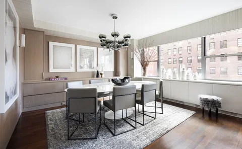 a living room with furniture a window and a chandelier