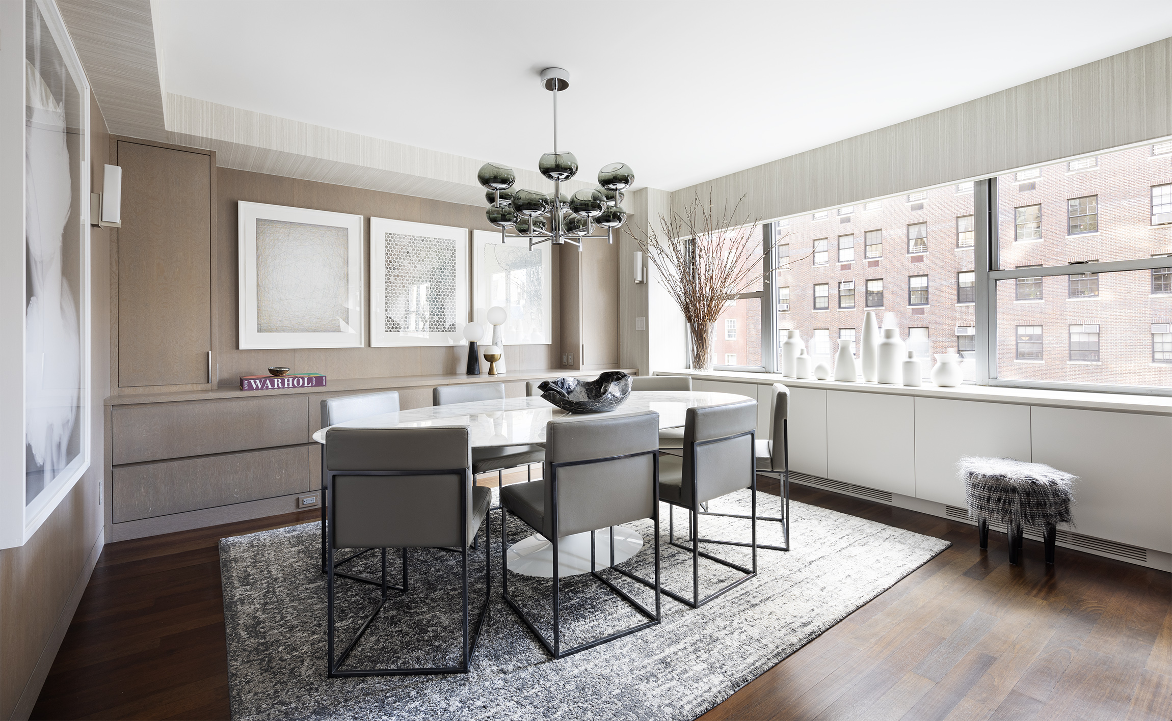 45 East 72nd Street, Unit 9C Manhattan, NY 10021 - Photo 3 of 16 a living room with furniture a window and a chandelier
