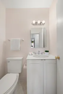 a spacious bedroom with a bed and chair