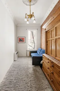 a spacious bedroom with a bed and a chandelier