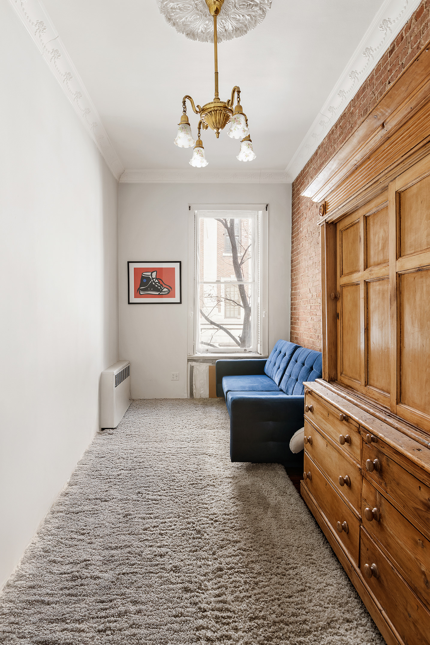 138 West 73rd Street Manhattan, NY 10023 - Photo 14 of 35 a spacious bedroom with a bed and a chandelier