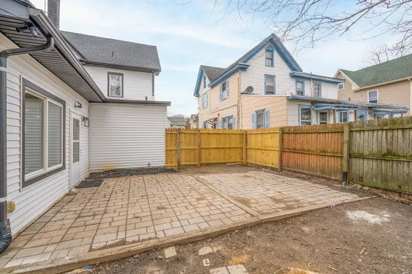 a view of a house with a wooden fence