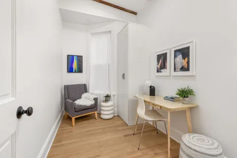 a living room with furniture and a chair