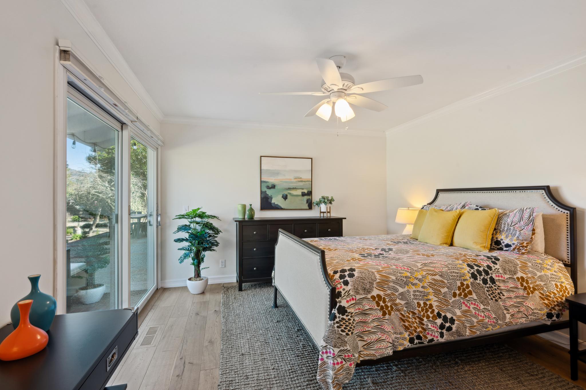 123 Frey Road Santa Rosa, CA 95409 - Photo 38 of 62 a bedroom with a large bed and a chandelier