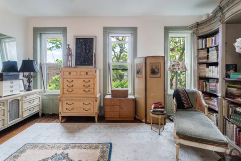 a bedroom with furniture and a window