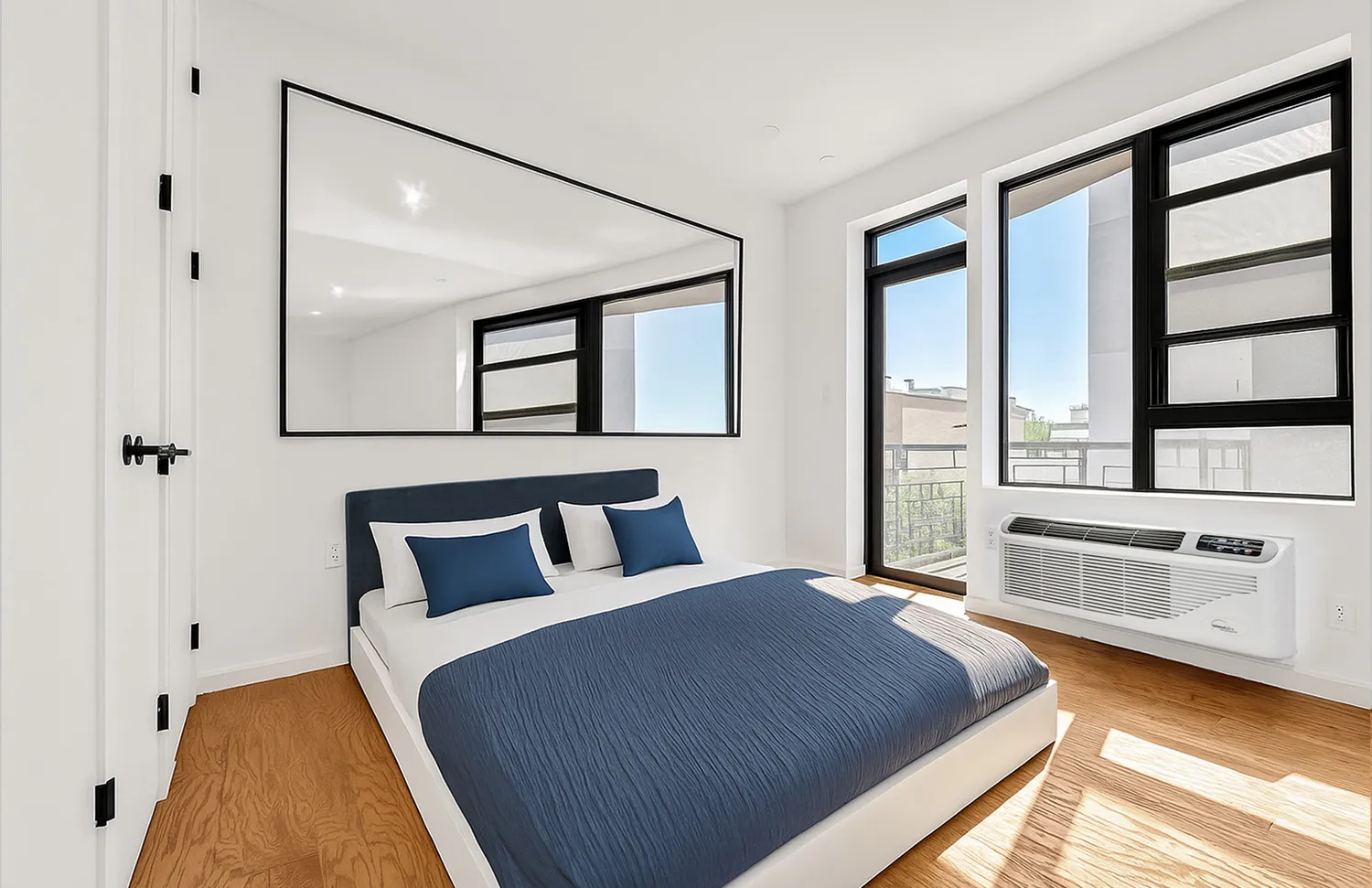 a bedroom with a large bed and a large window