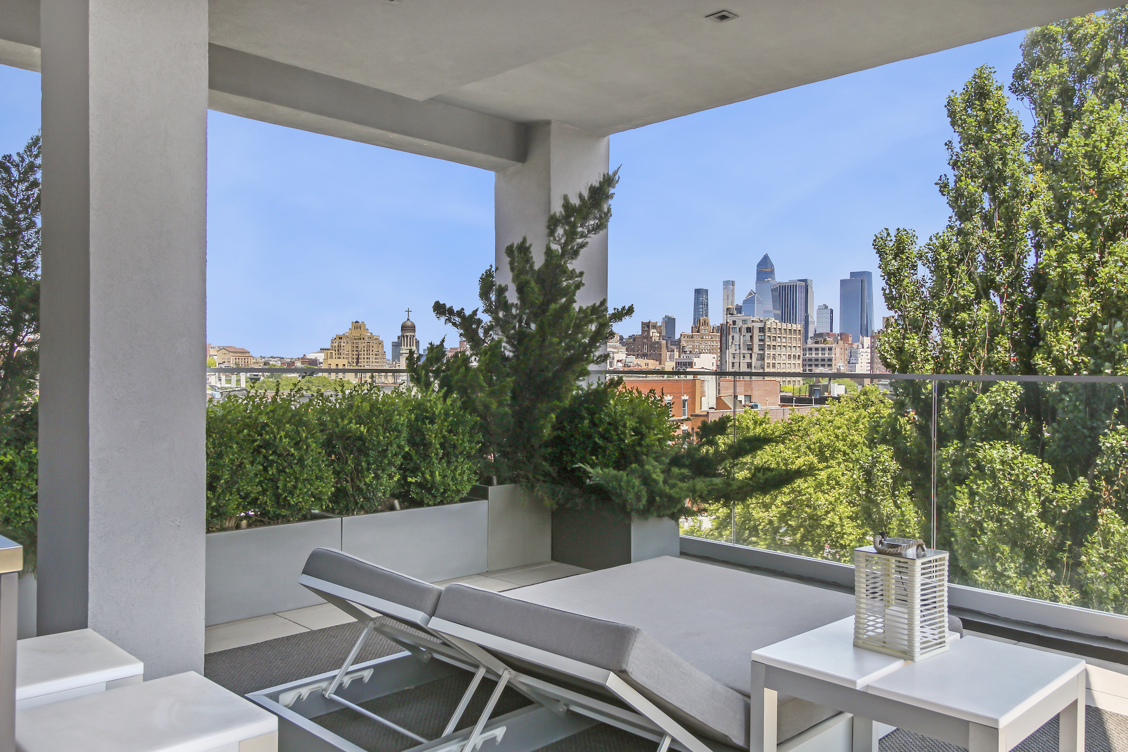 136 West Houston Street, Unit PH Manhattan, NY 10012 - Photo 10 of 26 a view of a balcony with table and chairs and a potted plant