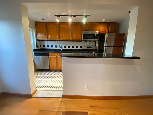 a kitchen with stainless steel appliances a refrigerator and a stove
