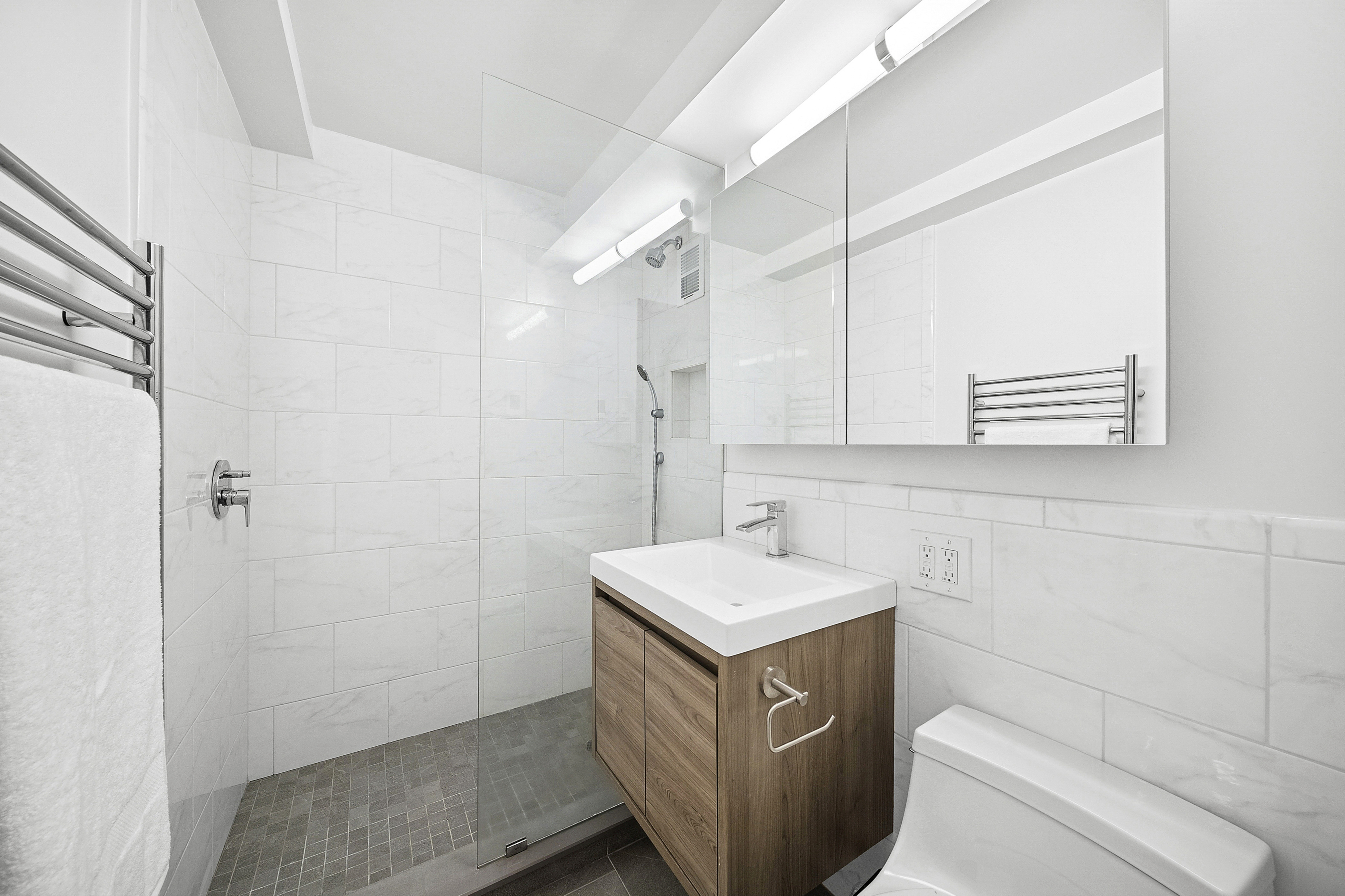54 West 16th Street, Unit 2G Manhattan, NY 10011 - Photo 4 of 7 a bathroom with a sink a vanity and a mirror